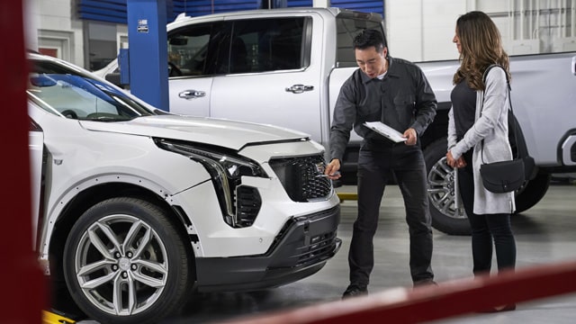 Mechanic handling car air filter during engine maintenance, emphasizing automotive care and air filter replacement.