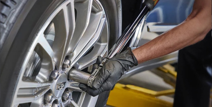 Mechanic handling car air filter during engine maintenance, emphasizing automotive care and air filter replacement.