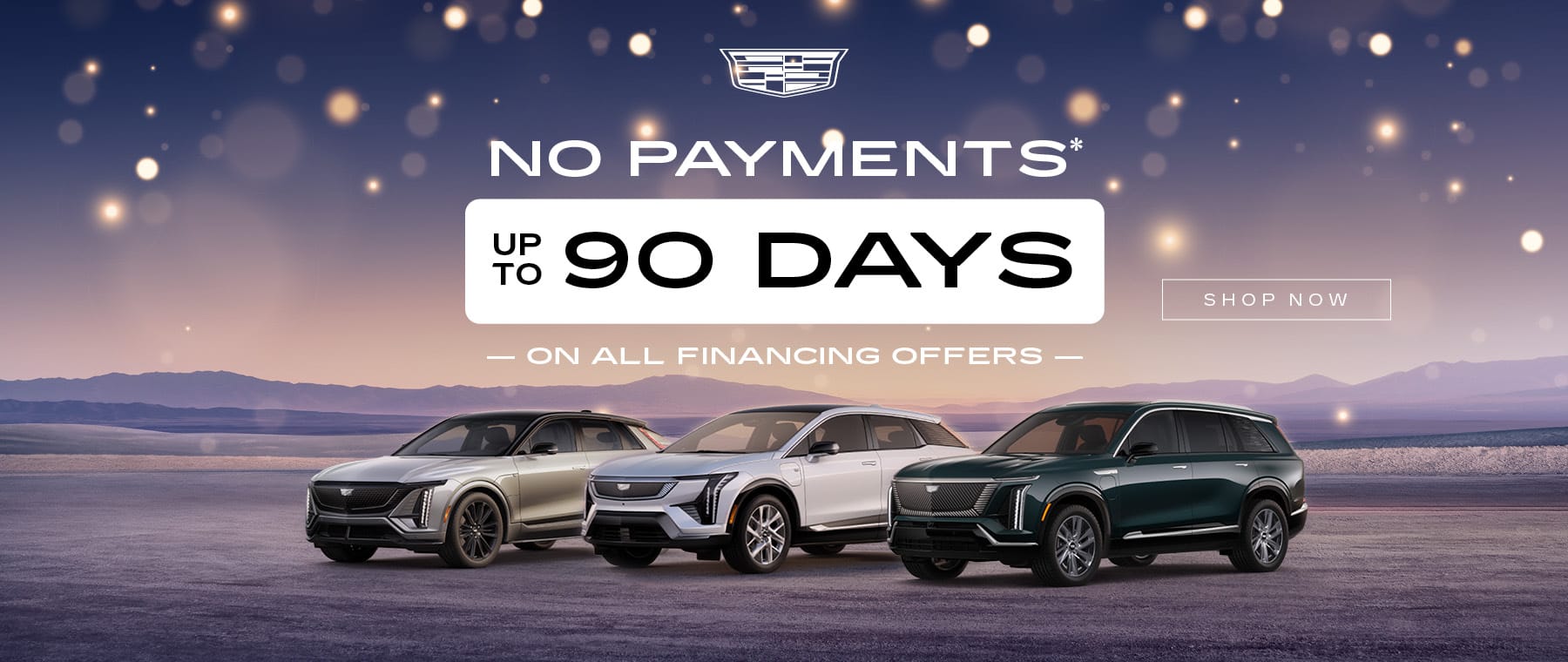 Cadillac vehicles on display with "No Payments for 90 Days" offer. Scenic desert backdrop.